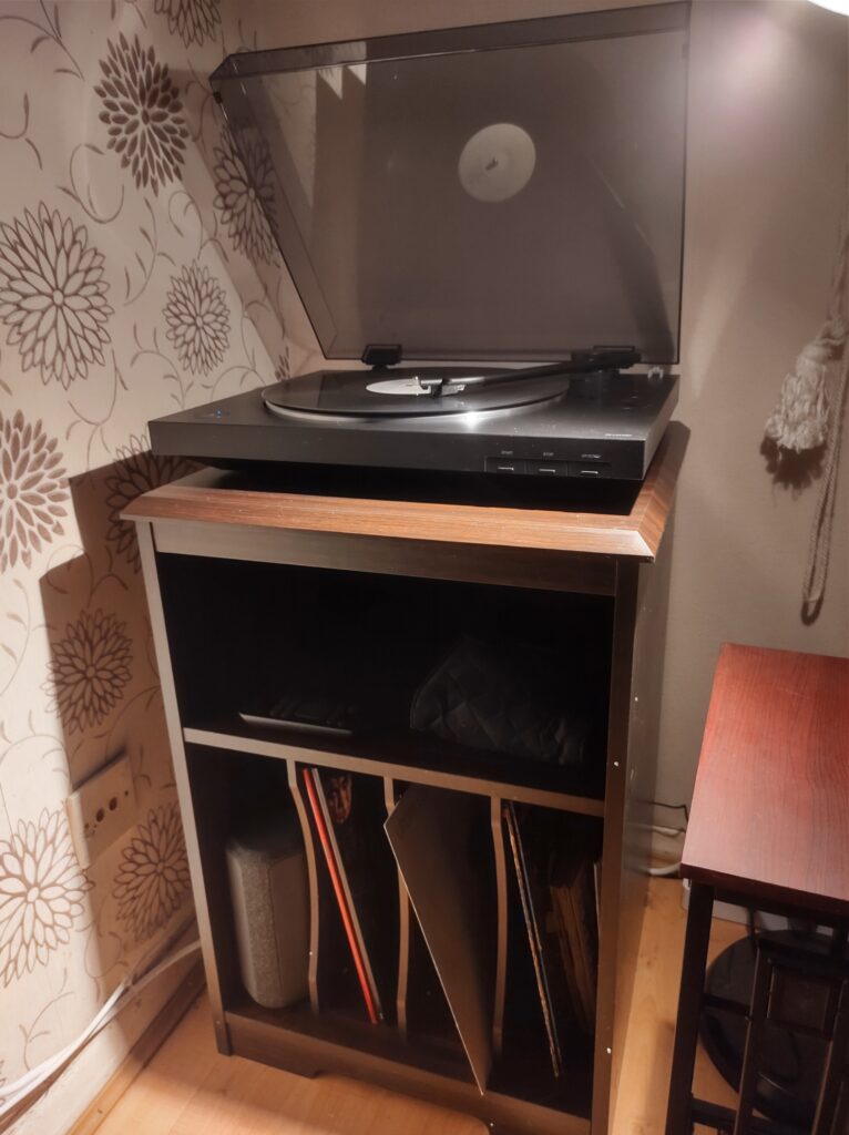Sony turntable on top of a cabinet with room for about 50 albums